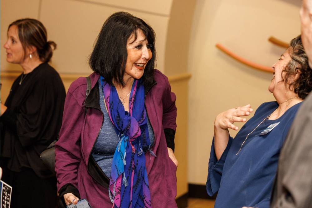 President Philomena Mantella (middle) laughing with Dr. Samhita Rhodes (right)